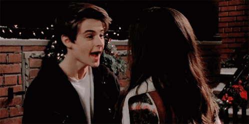 A Boy And A Girl Are Looking Into Each Other 'S Eyes GIF