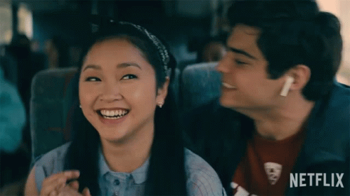 A Boy And A Girl Are Sitting Next To Each Other On A Bus With Netflix Written On The Bottom GIF