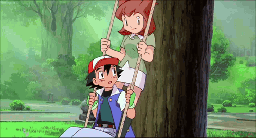 a boy and a girl are sitting on a tree swing .