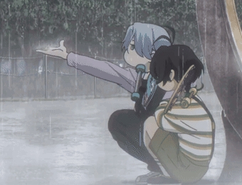 A Boy And A Girl Are Squatting In The Rain And The Girl Is Pointing At Something GIF