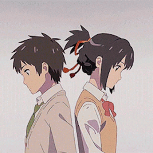 A Boy And A Girl Are Standing Back To Back With Their Heads Together . GIF