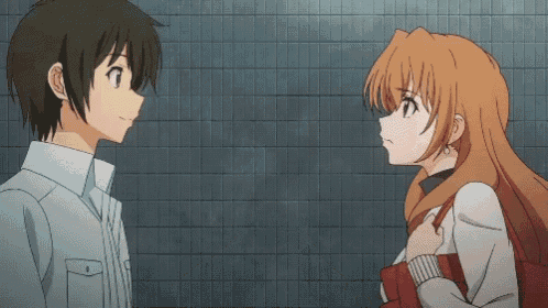 A Boy And A Girl Are Standing Next To Each Other And The Boy Is Pointing At The Girl GIF