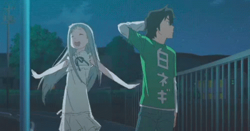 A Boy And A Girl Are Standing Next To Each Other And The Boy Is Wearing A Green Shirt With Chinese Writing On The Back GIF