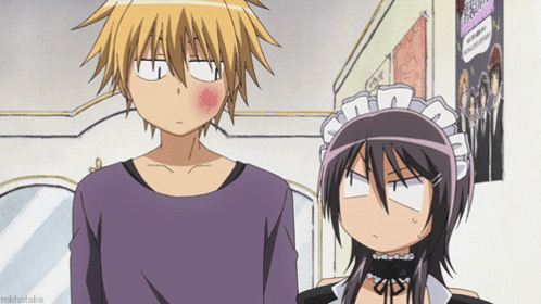 A Boy And A Girl Are Standing Next To Each Other And The Girl Has A Red Cheek GIF