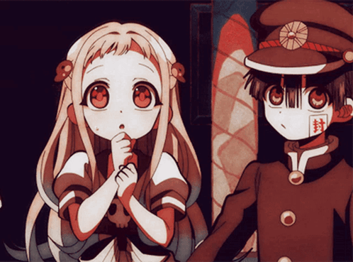 A Boy And A Girl Are Standing Next To Each Other And The Girl Has A Skull In Her Hair GIF