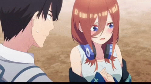 A Boy And A Girl Are Standing Next To Each Other And The Girl Has Headphones On Her Head GIF