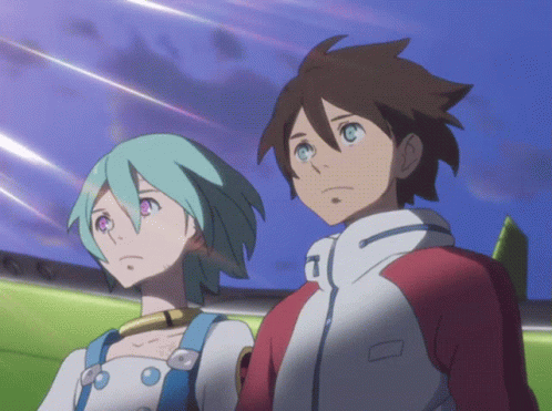 A Boy And A Girl Are Standing Next To Each Other And The Girl Has The Letter T On Her Jacket GIF