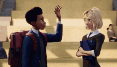 A Boy And A Girl Are Standing Next To Each Other In A Classroom . The Boy Is Waving At The Girl . GIF