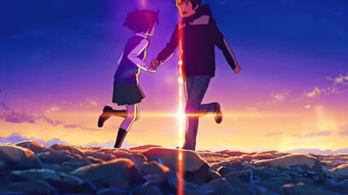 A Boy And A Girl Are Standing Next To Each Other In A Field Holding Hands GIF