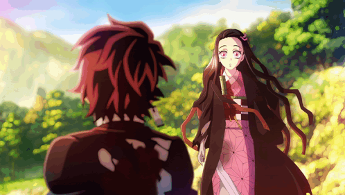 A Boy And A Girl Are Standing Next To Each Other In A Forest GIF