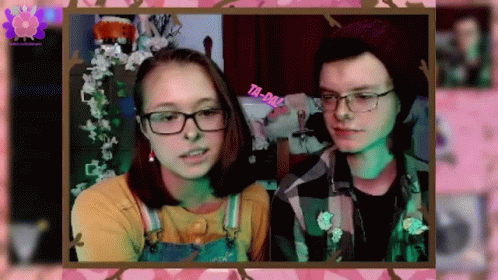 A Boy And A Girl Are Standing Next To Each Other In A Frame . GIF