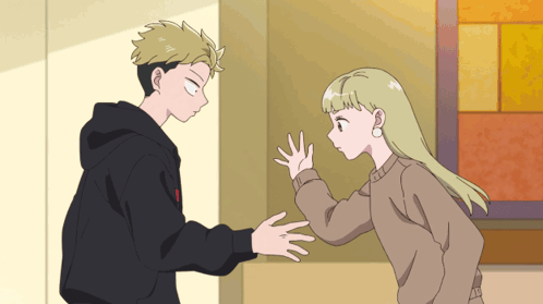A Boy And A Girl Are Standing Next To Each Other In A Room GIF