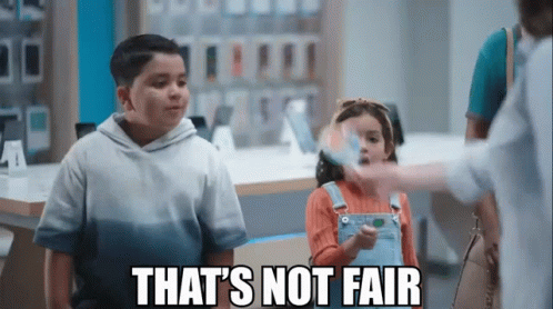 A Boy And A Girl Are Standing Next To Each Other In A Store With The Words That 'S Not Fair Written Above Them . GIF