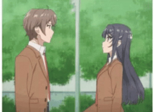 A Boy And A Girl Are Standing Next To Each Other In Front Of Trees . GIF
