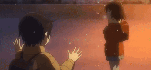 A Boy And A Girl Are Standing Next To Each Other Waving Their Hands In The Air . GIF