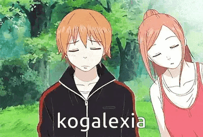 a boy and a girl are standing next to each other with their eyes closed .