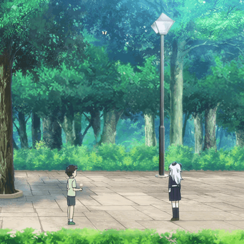 A Boy And A Girl Are Standing On A Sidewalk In The Woods GIF