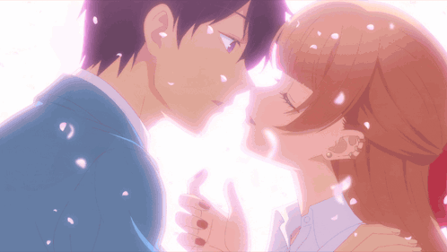 A Boy And A Girl Kissing With Petals Falling Around Them GIF
