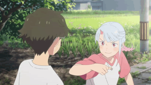 A Boy And A Girl Standing Next To Each Other GIF
