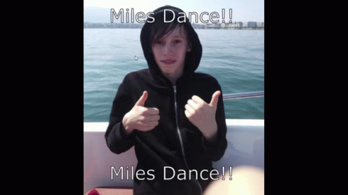 a boy in a black hoodie giving a thumbs up with the words miles dance