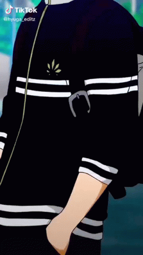 A Boy In A Black Jacket Is Smoking A Cigarette While Standing On A Street . GIF