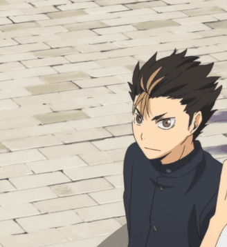A Boy In A Black Jacket Is Standing On A Sidewalk GIF