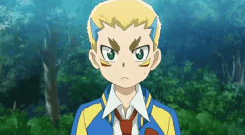 A Boy In A Blue And Yellow Jacket And Tie Is Standing In Front Of Trees . GIF