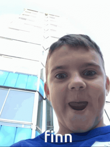 A Boy In A Blue Shirt With Finn Written On It GIF