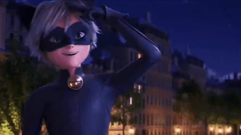 A Boy In A Cat Noir Costume Is Waving At The Camera . GIF