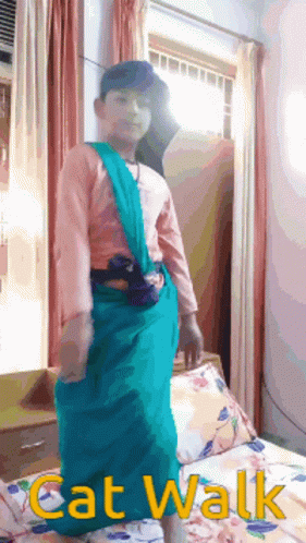 A Boy In A Cat Walk Costume Is Standing In Front Of A Window GIF