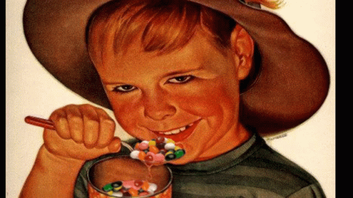 A Boy In A Cowboy Hat Is Eating Cereal With A Spoon And Smiling GIF