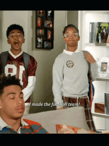 A Boy In A Football Jersey Says " I Made The Football Team " Next To A Girl GIF