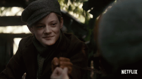 A Boy In A Hat Is Smiling In A Netflix Advertisement GIF