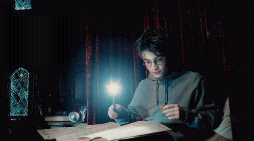 A Boy In A Hoodie Is Holding A Wand In His Hand GIF
