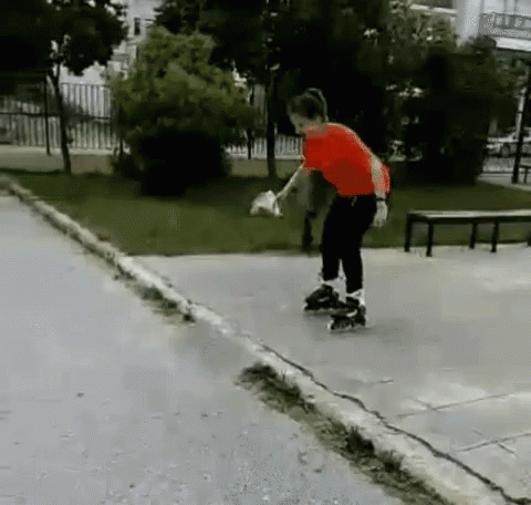 A Boy In A Red Shirt Rollerblading Down A Sidewalk GIF