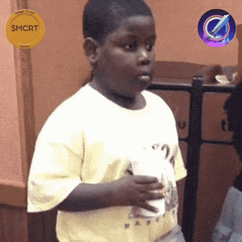 A Boy In A White Shirt Is Holding A Cup And A Gold Coin That Says Smcrt GIF