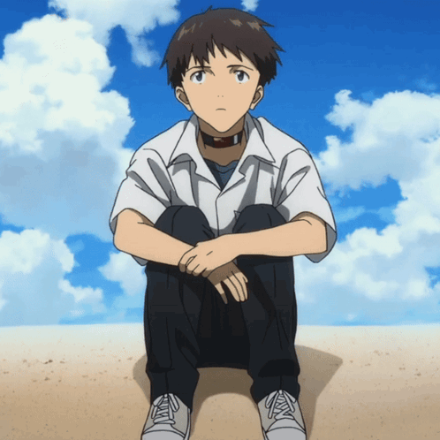 A Boy In A White Shirt Is Sitting On The Ground With His Legs Crossed GIF