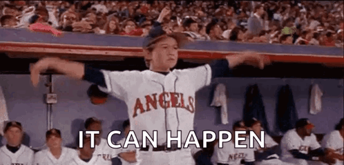 A Boy In An Angels Baseball Uniform Is Standing In The Dugout . GIF