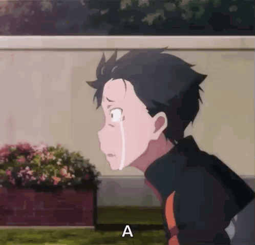 A Boy Is Crying While Standing In Front Of A Planter Of Flowers . GIF