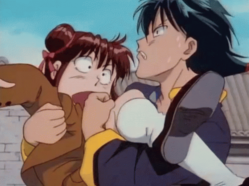 A Boy Is Holding A Girl In His Arms And The Girl Is Making A Funny Face GIF