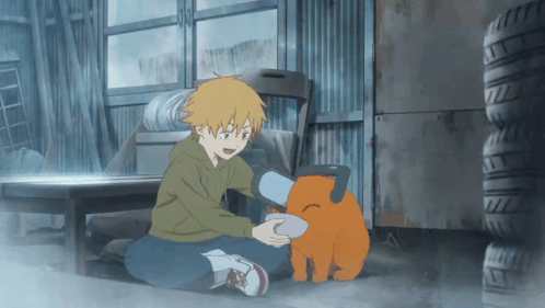 A Boy Is Kneeling Down Next To A Stuffed Animal That Looks Like A Dog GIF