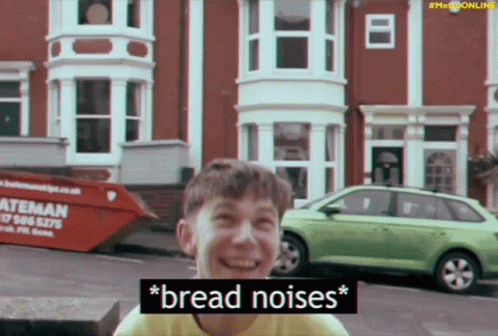A Boy Is Laughing In Front Of A Dumpster That Says " Bread Noises " On It GIF