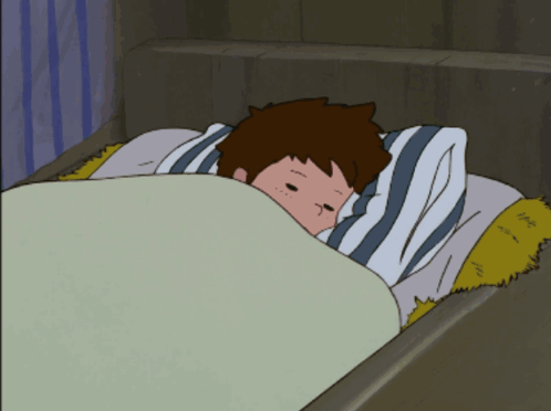 a boy is laying in bed with a striped pillow