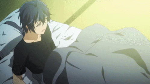 A Boy Is Laying On A Bed With A Blanket GIF