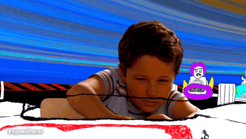 A Boy Is Laying On A Drawing Of A Race Track With #Speedracer Written On The Bottom GIF