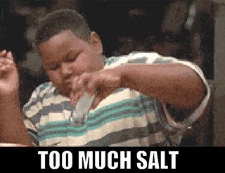 A Boy Is Pouring Salt Into His Mouth With The Words Too Much Salt Below Him GIF
