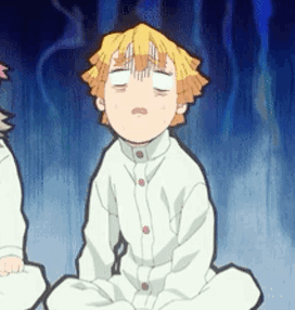 A Boy Is Sitting On The Floor With His Eyes Closed . GIF