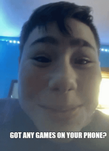 A Boy Is Smiling With The Words Got Any Games On Your Phone Below His Face GIF