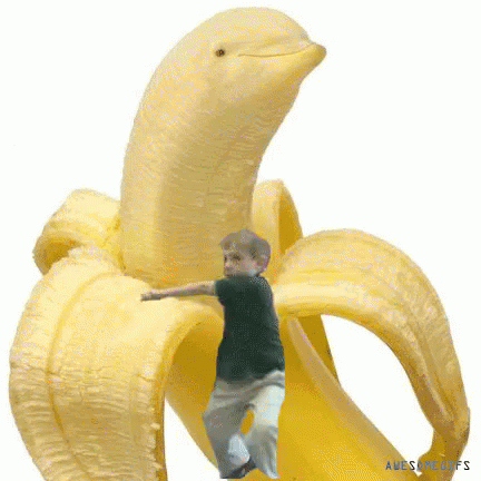 A Boy Is Standing Inside Of A Banana That Is Shaped Like A Dolphin . GIF