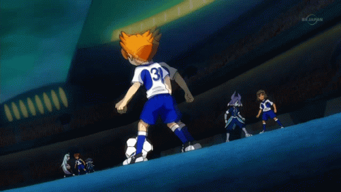A Boy Kicking A Soccer Ball In Front Of A Stadium That Says Tvtokyo GIF